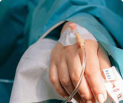 A patient is holding an iv in her hand.