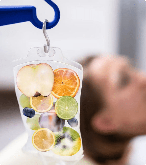 A person is looking at the fruit in a container.