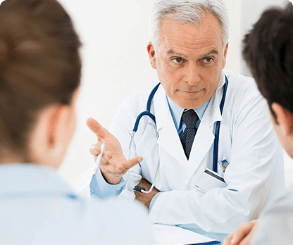 A doctor is talking to two other doctors.