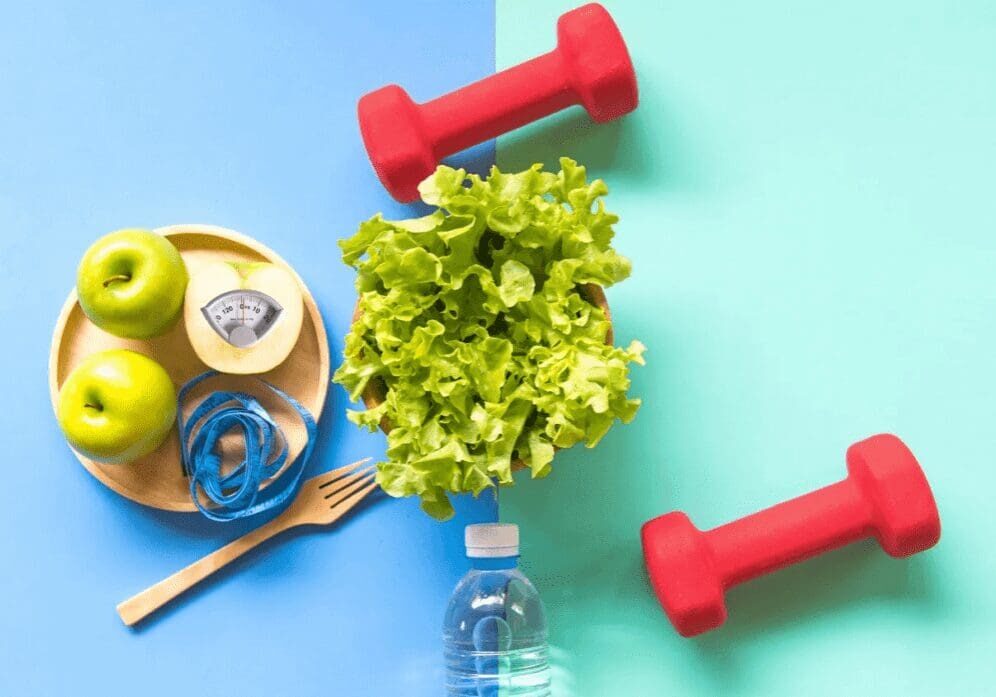 Healthy lifestyle with dumbbells, salad, and apples.